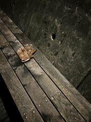 Gloves on a bench in nighttime..