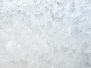 close-up of ice crystals pattern. frosty pattern. nature pattern. frozen water texture. winter frost. ice texture. white minimalistic background