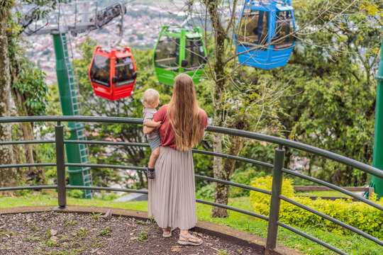 Mom and her baby son tourists in front of the panoramic view of Orizaba from Cerro del Borrego, Mexico. Travel, scenic landscape, and adventure concept