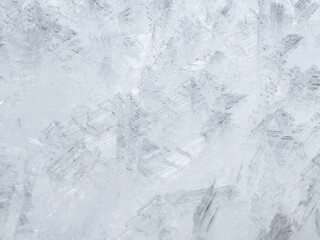 close-up of ice crystals pattern. frosty pattern. nature pattern. frozen water texture. winter frost. ice texture. white minimalistic background