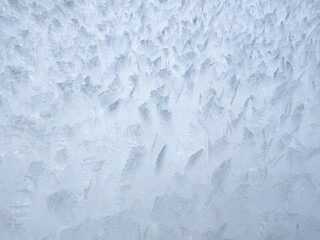 close-up of ice crystals pattern. frosty pattern. nature pattern. frozen water texture. winter frost. ice texture. white minimalistic background