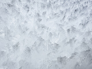 close-up of ice crystals pattern. frosty pattern. nature pattern. frozen water texture. winter frost. ice texture. white minimalistic background