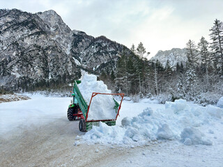 truck loaded with snow in snowy mountain landscape. snow drifts. winter. snow removal. snowplow....