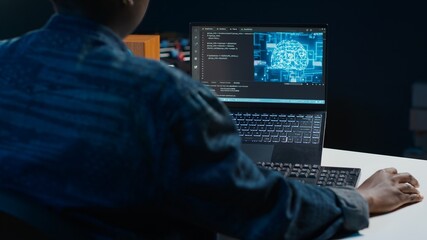 AI professional in home office using laptop to write programming language code. Artificial intelligence engineer working from home using notebook device to build application, camera A