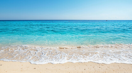 Fototapeta premium Serene tropical beach with clear turquoise waters and gentle waves under a bright blue sky