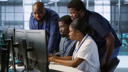 Fototapeta premium Coworkers in data center doing brainstorming, implementing AI predictive maintenance systems. Server hub colleagues discussing, using artificial intelligence to identify hardware failures, camera A