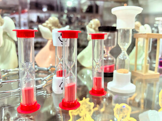 Unique hourglass collection displayed in a vibrant artisan shop setting