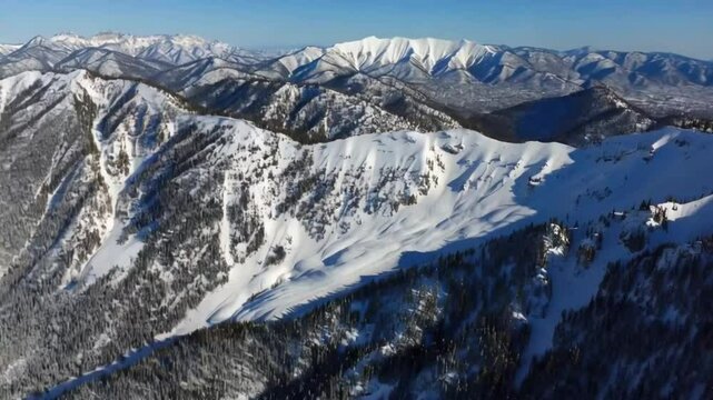 Cinematic Mammoth Mountain Ski Area resort aerial 4K. Beautiful Mountain Range Winter Inspiring Landscape. Flight footage over epic snowy cold peaks. Nature panorama sunny winter day. Winter vacation
