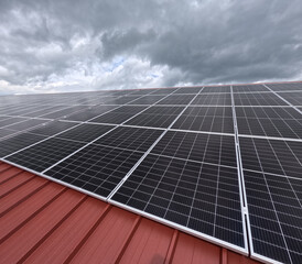 Extensive Solar Panel Array on the Metal Roof of a Large Industrial Facility