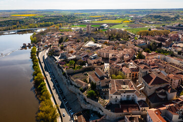 Scenic drone view of ancient walled Spanish city of Zamora on bank of Duero River overlooking...