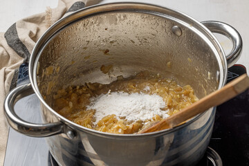 Adding flour to caramelized onions