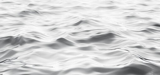 Metallic liquid surface creating an abstract pattern of waves, perfect for backgrounds and designs related to fluidity, technology, and modern aesthetics