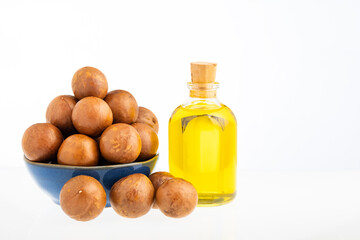 Macadamia integrifolia - Macadamia nuts with bottle of organic oil.
