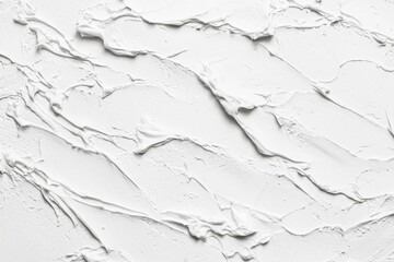 Obraz premium Close-up of a textured white plaster surface featuring abstract patterns and swirling lines. The smooth and rough textures create a dynamic visual effect, ideal for backgrounds or design elements