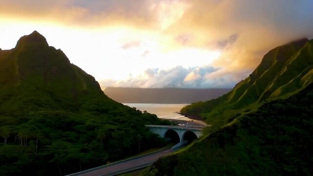 Scenic route on Oahu Hawaii island at golden sunrise. Interstate H3 passing through majestic green Koolau Mountains with Trans-Koolau twin tunnels. Aerial along highway with epic nature landscape view