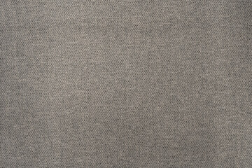 Close-up of a gray rough textured fabric which can be used for fashion, clothes, furniture, and background art designs.