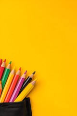 Colorful Pencils on Bright Yellow Background