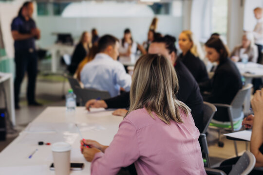 Audience team on master class seminar, working together during contest competition in the auditorium class, corporate workshop, company coworkers and colleagues listen to lecturer on a conference