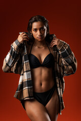 Photo of Hispanic model wearing long-sleeved shirt and flat abdomen