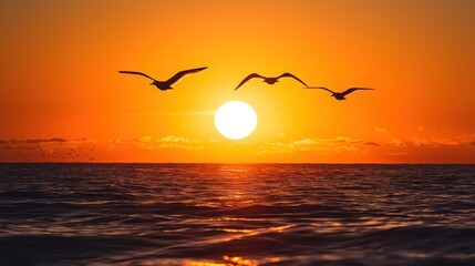 Obraz premium A vibrant golden sunset with silhouettes of birds flying over the sea