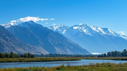 A breathtaking view of towering snow-capped mountains under a clear blue sky