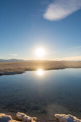 beautiful sunset with a sun reflection in a lake in salinas grandes, salt flat in the andean altiplano Jujuy, Argentina