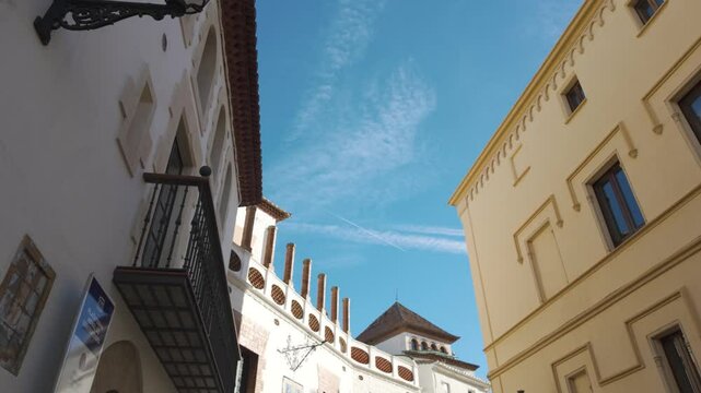 Traditional architecture with balconies and chimneys creating a picturesque scene in sitges, catalonia, under a vibrant blue sky