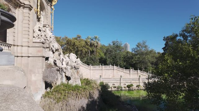 Establishing exterior of iconic Cascada Monumental fountain in Parc de la Ciutadella, Barcelona, under sunny skies