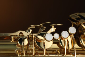 Obraz premium Jazz. One beautiful saxophone on brown background, closeup