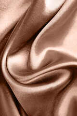 Fototapeta premium Silk fabric in mocha mousse shade, closeup. Trendy color of 2025 year