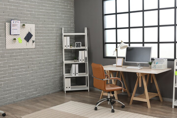 Naklejka premium Interior of modern office with workplace and pegboard