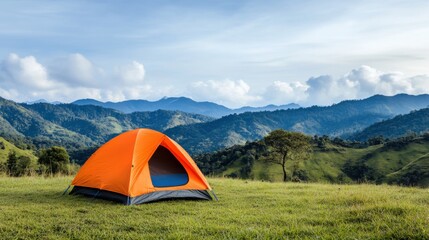 Vibrant Orange Tent Set Against Majestic Mountain Landscape under Clear Blue Sky