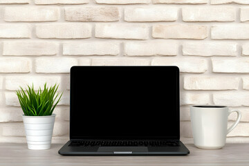 Laptop, coffee, plant, brick wall, workspace