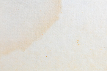 Textured close-up of an aged stained paper with natural discoloration patterns