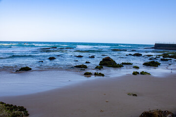 Stunning ocean view from Bondi Beach, Sydney. Rocky and sandy shoreline meets the azure waves under a bright sky, capturing the essence of this iconic Australian destination.