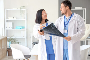 Fototapeta premium Doctors studying x-ray image of spine in clinic