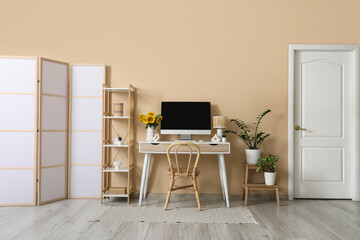 Interior of office with workplace, shelf unit and plants