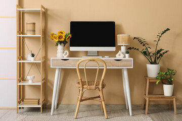 Interior of office with workplace, shelf unit and plants
