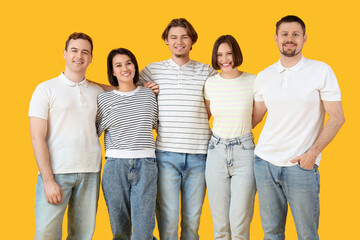 Fototapeta premium Diverse group of five young adults smiling together, friendship and community concept, isolated on a bright yellow background