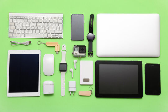 Set of modern devices on green background, top view - Powered by Adobe