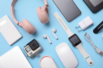 Set of modern devices on blue background, top view