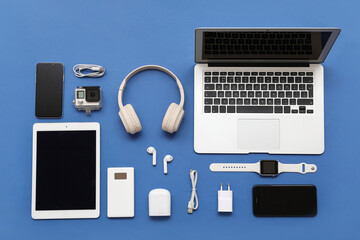 Composition with different modern gadgets on blue background