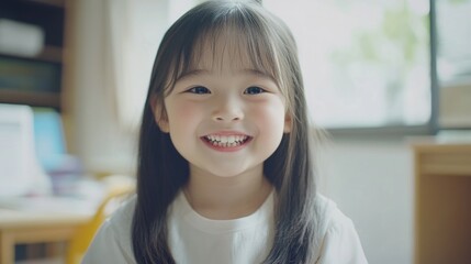 Smiling Asian girl child engaged in online learning at home using tablet, bright classroom setting with natural light and cheerful atmosphere.