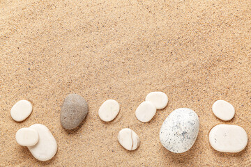 Different pebbles on beach sand