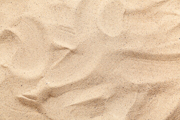 Texture of beige beach sand as background
