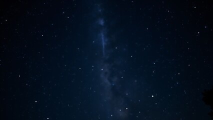 A deep sky with a singular beam of light from the Milky Way, illuminating the surrounding stars.