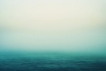 Obraz premium Serene ocean view with misty horizon at dawn, evoking tranquility and calmness