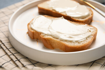 Plate of tasty bruschetta with processed cheese on napkin. Closeup