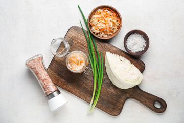 Piece of cabbage, salt, green onion and sauerkraut on white background. Top view