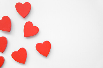 Heart shaped figurines on white background. Valentine's Day celebration